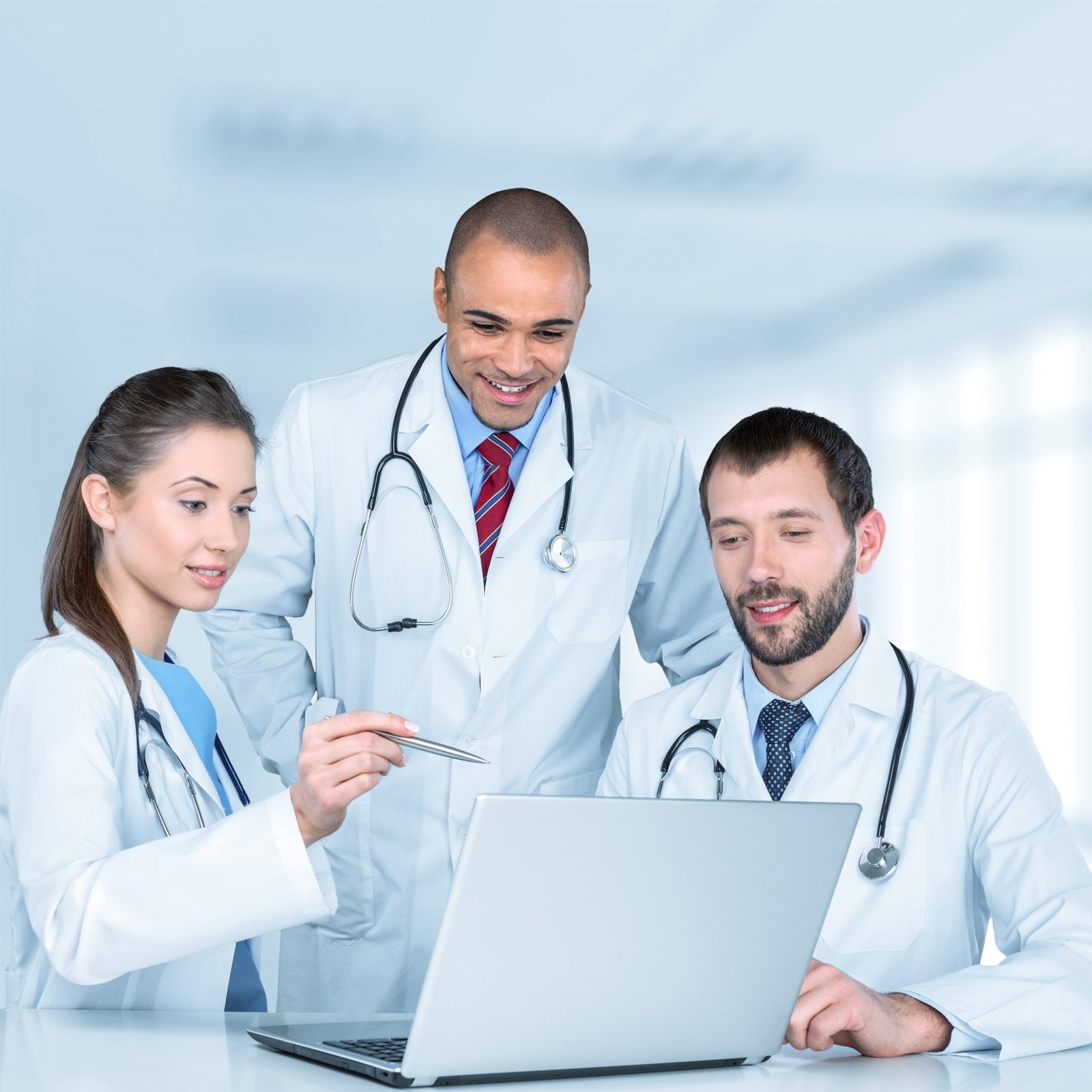 Three healthcare professionals reviewing information together